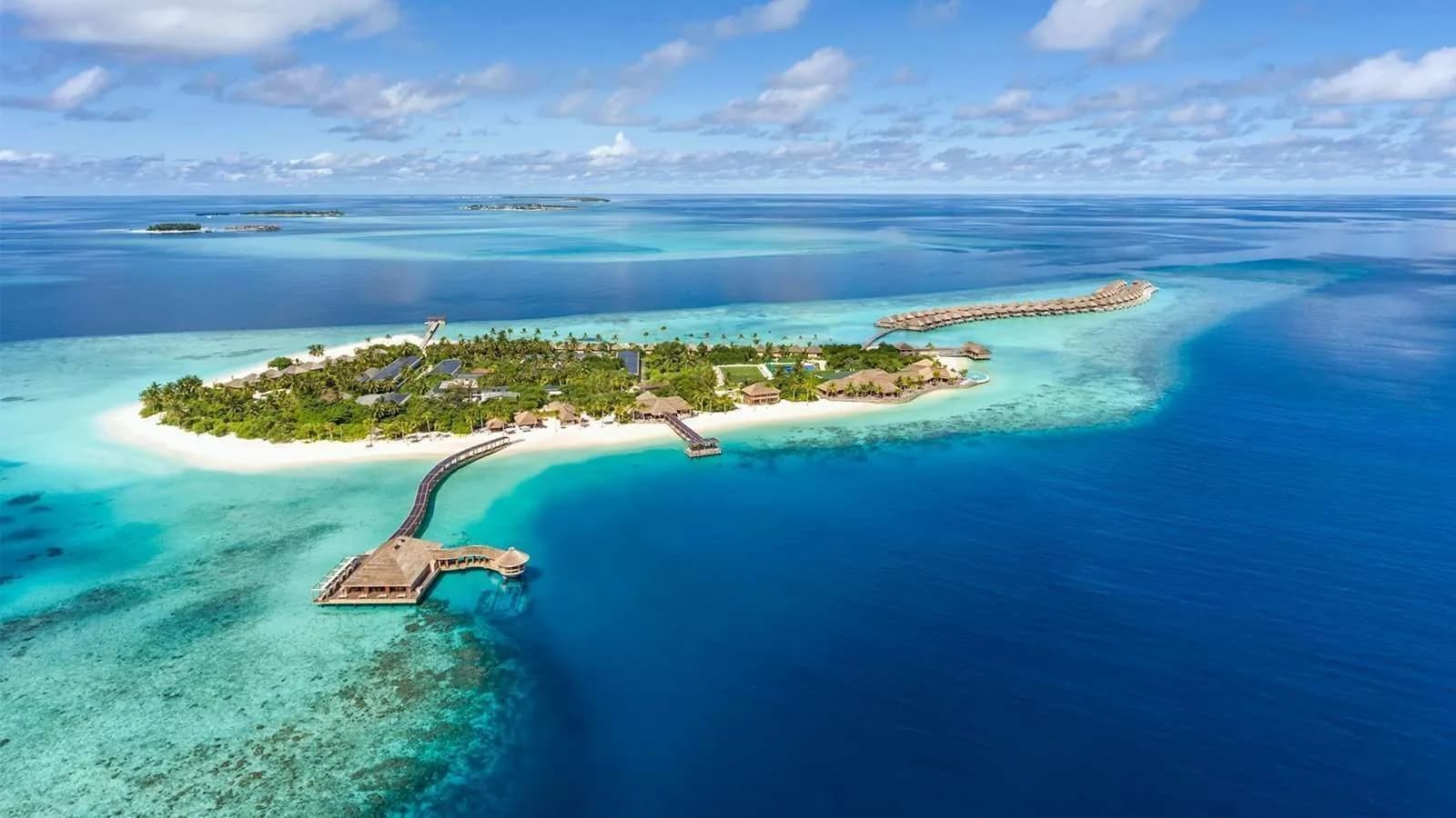 maldives guides, Maldives, aerial of a resort island, its over-water spa pavilion and reef edge