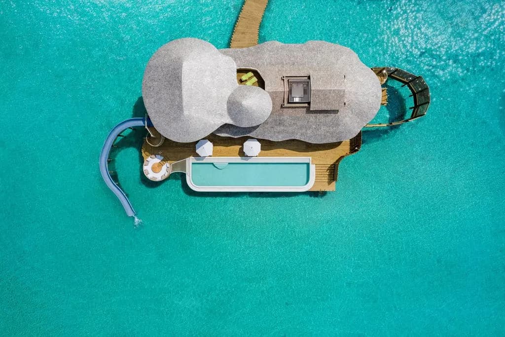 maldives when to visit, Maldives, an aerial of over-water villas over a clear dry-season lagoon