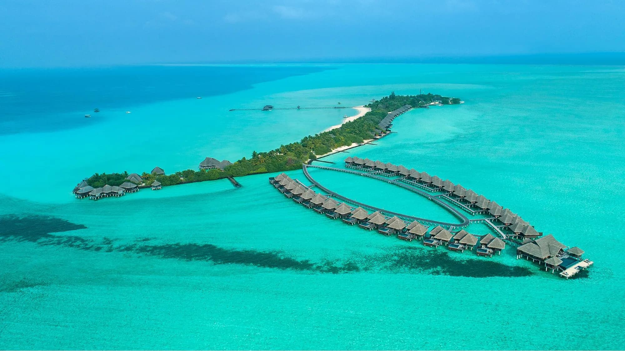 maldives honeymoon, Maldives, aerial of an island resort and its lagoon under clear dry-season skies