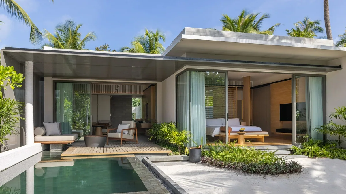 Alila Kothaifaru Maldives, Sunset Beach Pool Villa flat-roof pavilion with two open glass-fronted bays, green-tile plunge pool and wooden deck bridge, Raa Atoll, Maldives