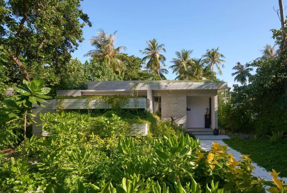 Alila Kothaifaru Maldives, Two Bedroom Beach Pool Villa with textured concrete walls, flat green-roof with grass planting and tropical jungle around entry, Raa Atoll, Maldives
