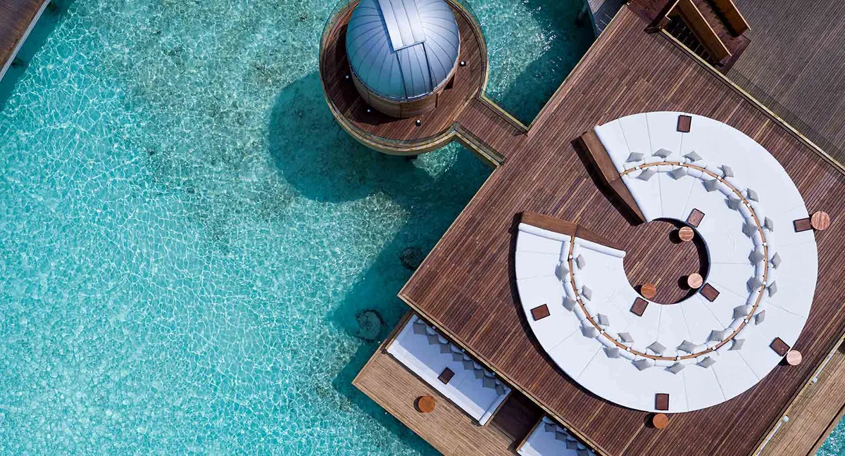 Anantara Kihavah Maldives Villas, observatory, Baa Atoll, Maldives, Sky Observatory deck birdseye: octagonal compass-rose deck with the small Meade telescope dome housing, U-shaped seating arranged for the equatorial-sky viewing programme, the rooftop position over the Sky Bar lagoon.