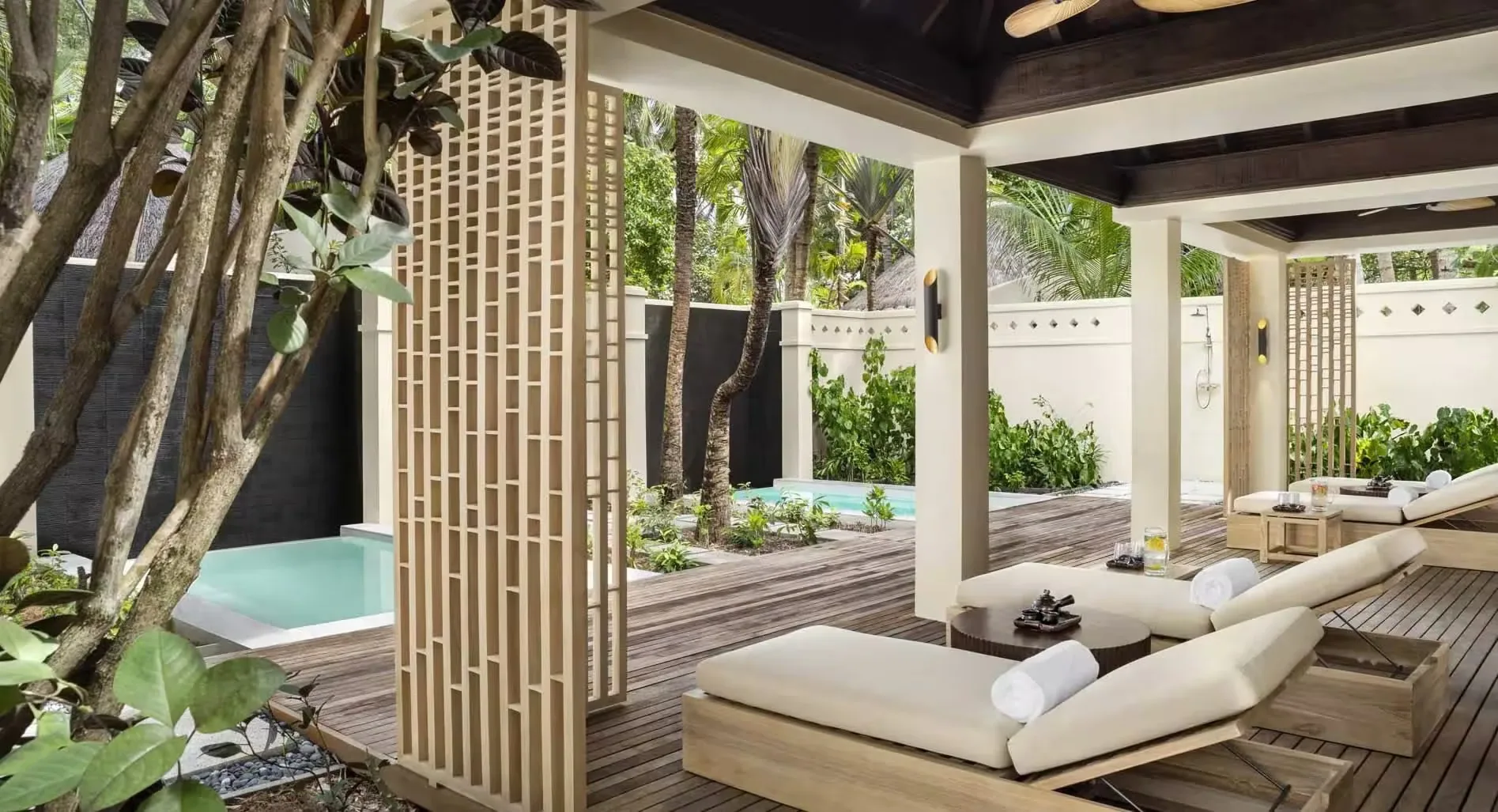 Anantara Veli Maldives Resort, spa, South Malé Atoll, Maldives, Balance Wellness relaxation garden, hot and cold plunge pools framed by white wood-screen walls and dark hardwood decking, twin daybeds under the pitched-roof cabana, the post-renovation hammam-and-pool zone.