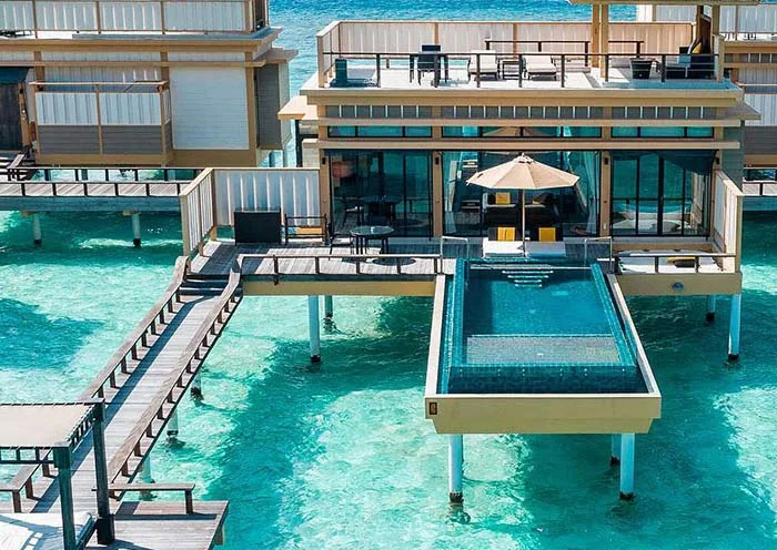Angsana Velavaru, aerial, Dhaalu Atoll, Maldives, Angsana Velavaru, the Velavaru island geometry in northern Dhaalu Atoll with the main-island beach-villa cluster plus the InOcean Villa cluster sitting one kilometre out in open ocean on a separate platform.
