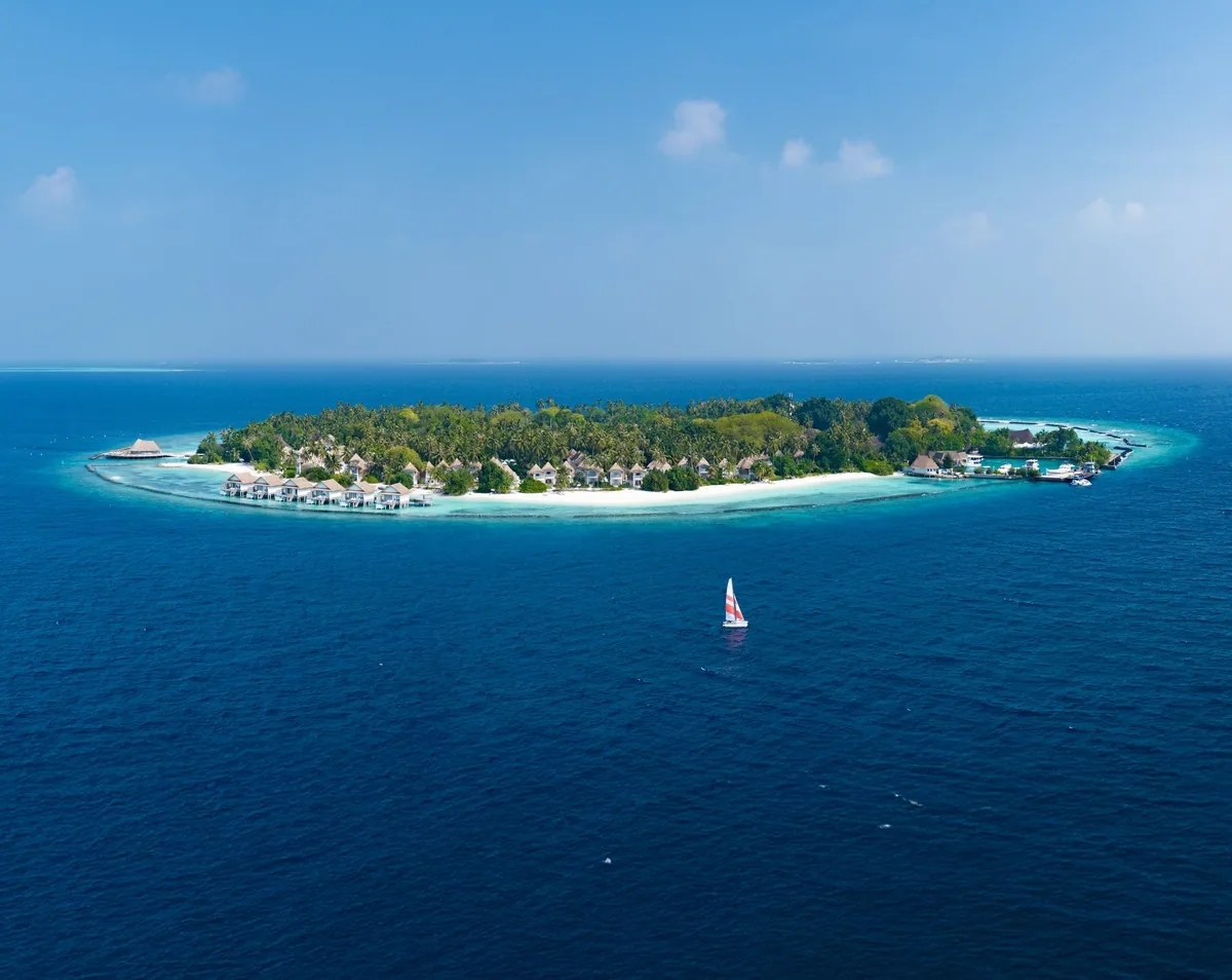 Bandos Maldives, aerial, North Malé Atoll, Maldives, Bandos Maldives, the Bandos natural-island geometry on the eastern edge of North Malé Atoll roughly 7 km north of Velana International.