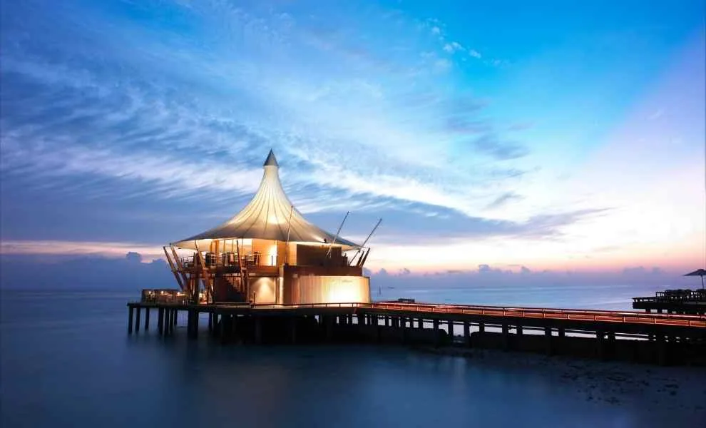 Baros Maldives, dining, North Malé Atoll, Maldives, Lighthouse Restaurant over-water fine-dining pavilion at the short-lagoon arrival approach.