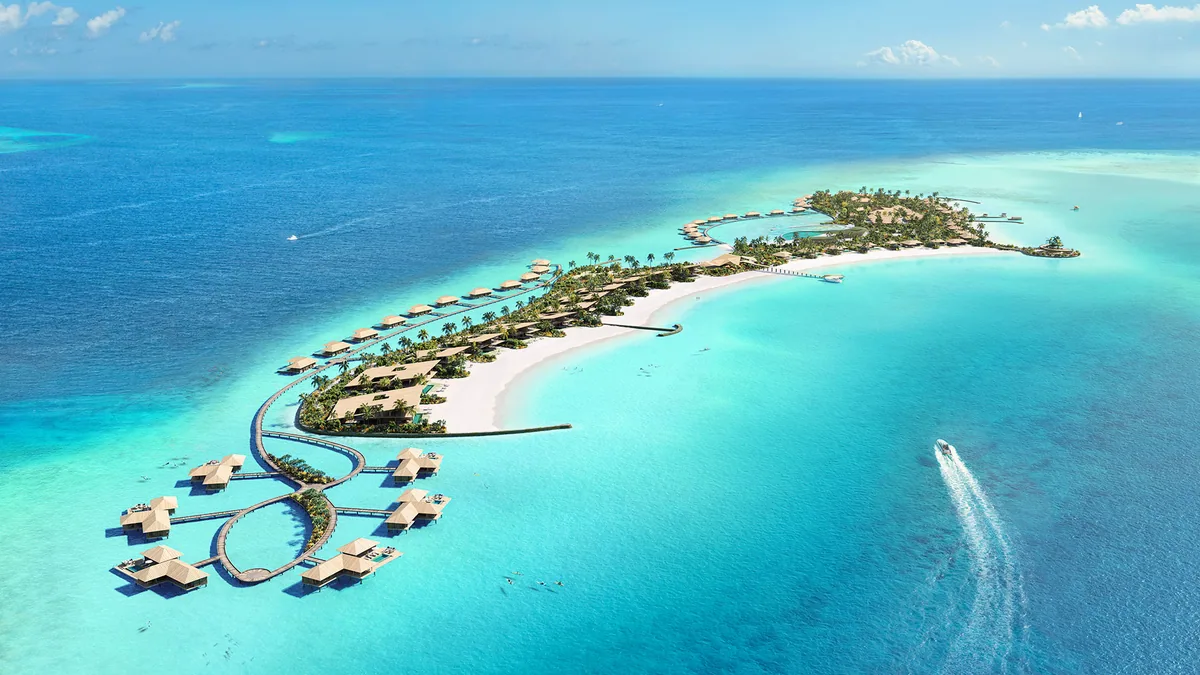 Capella Maldives, aerial, North Malé Atoll, Maldives, Press rendering of the Capella Maldives island layout at the Fari Islands cluster: thatched-pyramid villa cluster along the perimeter beach with figure-8 overwater walkway leading to a standalone overwater villa pod at the southern lagoon, palm-thick interior, sister property Patina visible at the upper right of the cluster.