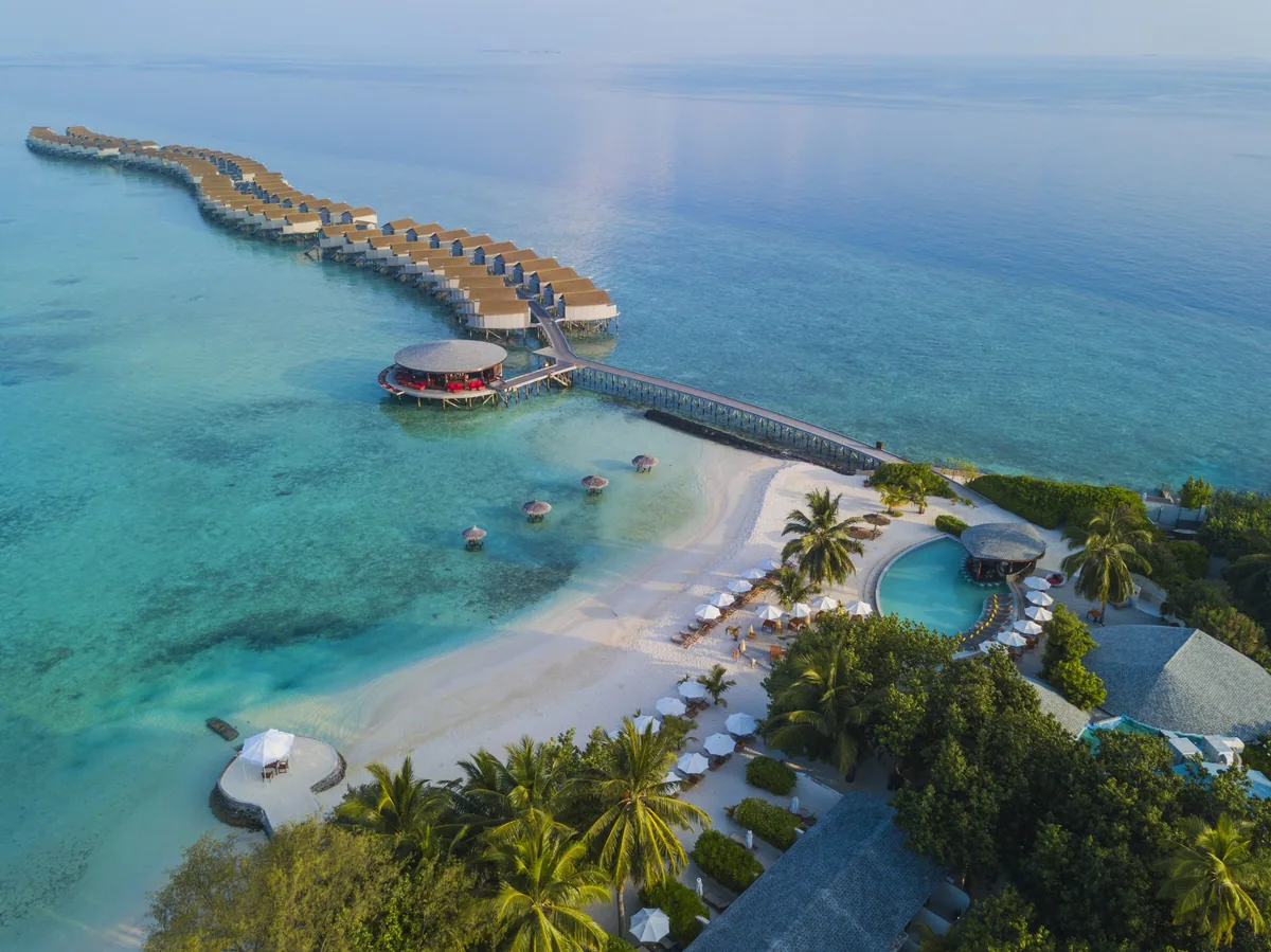 Centara Ras Fushi Resort & Spa, aerial, North Malé Atoll, Maldives, Centara Ras Fushi Resort & Spa, the Giraavaru natural-island geometry roughly 8 km west of Velana International with the over-water jetty cluster on the lagoon side.