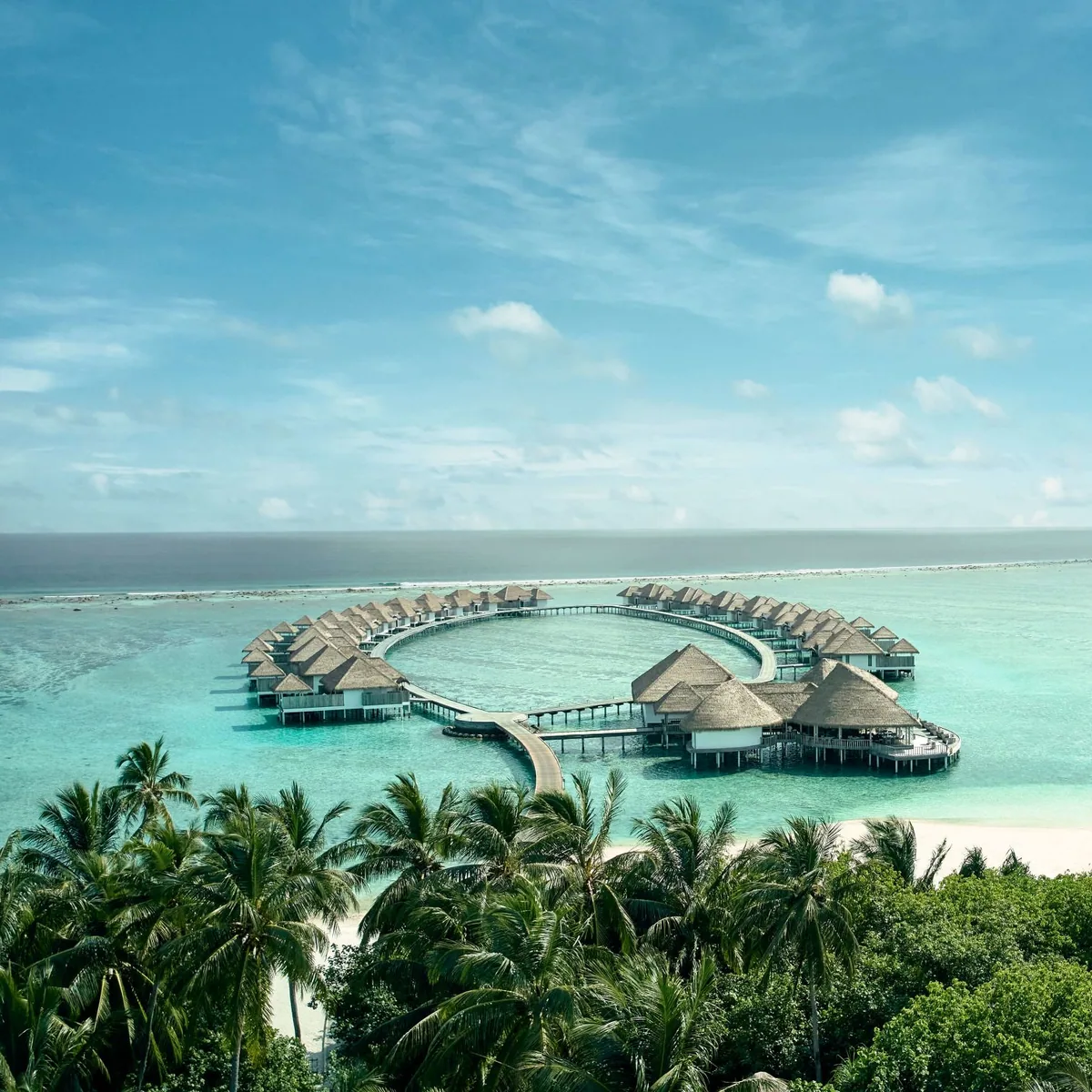 COMO Maalifushi, aerial, Thaa Atoll, Maldives, COMO Maalifushi, the Maalifushi island geometry in southern Thaa Atoll with the over-water cluster on the lagoon side and the perimeter beach configuration.
