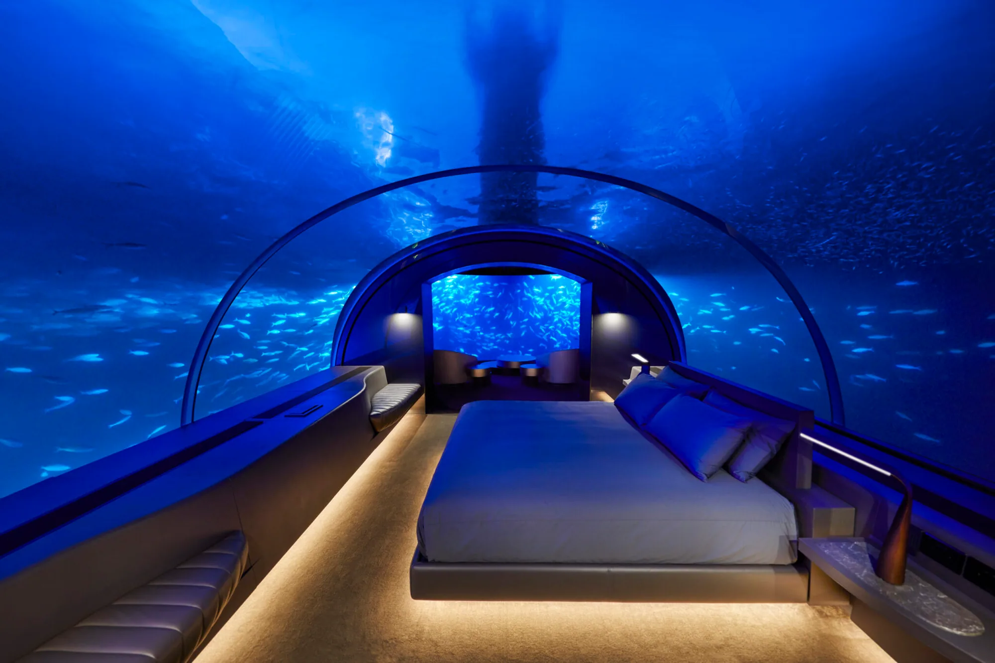 Conrad Maldives Rangali Island, villa underwater, Alif Dhaal (South Ari) Atoll, Maldives, The Muraka, world's first underwater residence master bedroom: 180 degree curved acrylic dome submerged 16 feet below the lagoon, king bed under warm uplighting with schools of reef fish wrapping the room.