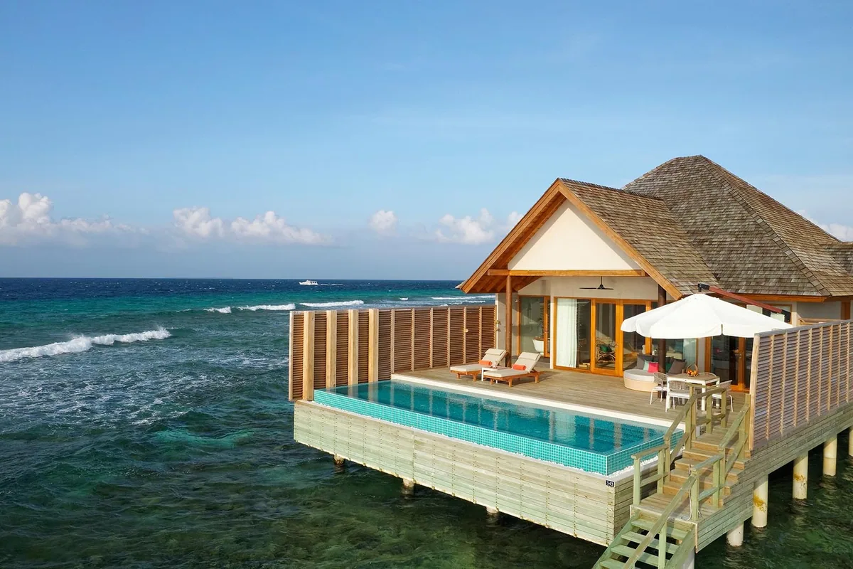 Emerald Faarufushi, Sunset Ocean Retreat with Pool pyramid-roof villa over reef with green mosaic plunge pool, sun loungers, bamboo privacy screen and reef waves, Raa Atoll, Maldives