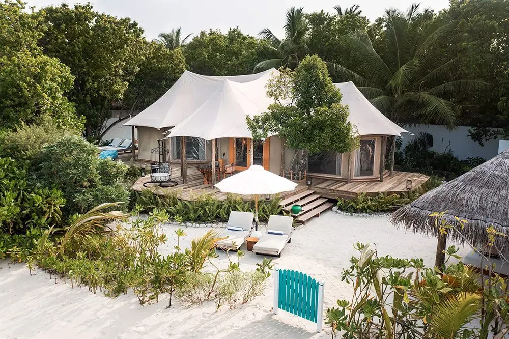 Sirru Fen Fushi Private Lagoon Resort, Safari Beach Villa tensile-fabric tent structure on beachfront with wooden deck, sun lounger, parasol and tropical garden, Shaviyani Atoll, Maldives