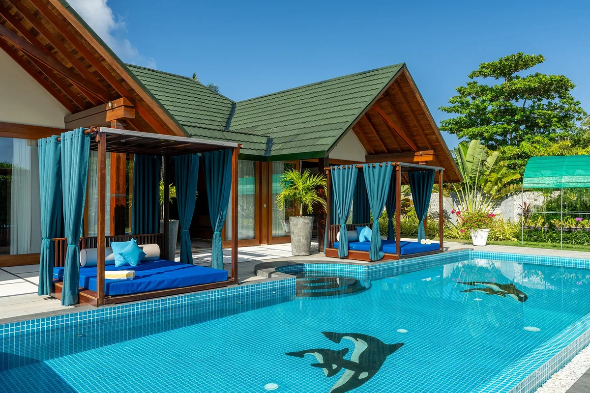 Furaveri Maldives, Family Beach Pool Villa with two green-tile pitched-roof pavilions, two draped four-poster daybeds and infinity-edge pool with manta-ray mosaic tile, Raa Atoll, Maldives