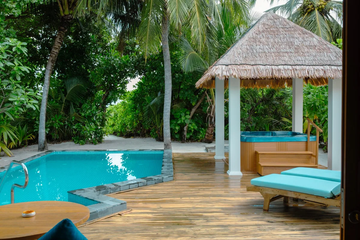 Furaveri Maldives, Wellness Village hot-tub pavilion with palm-thatched octagonal gazebo housing jacuzzi, small swimming pool and teal-cushion lounger, Raa Atoll, Maldives