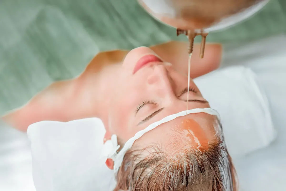 Fushifaru Maldives, spa, Lhaviyani Atoll, Maldives, Veyoge Spa Ayurvedic shirodhara treatment with a continuous warm-oil stream pouring onto the guest's forehead.