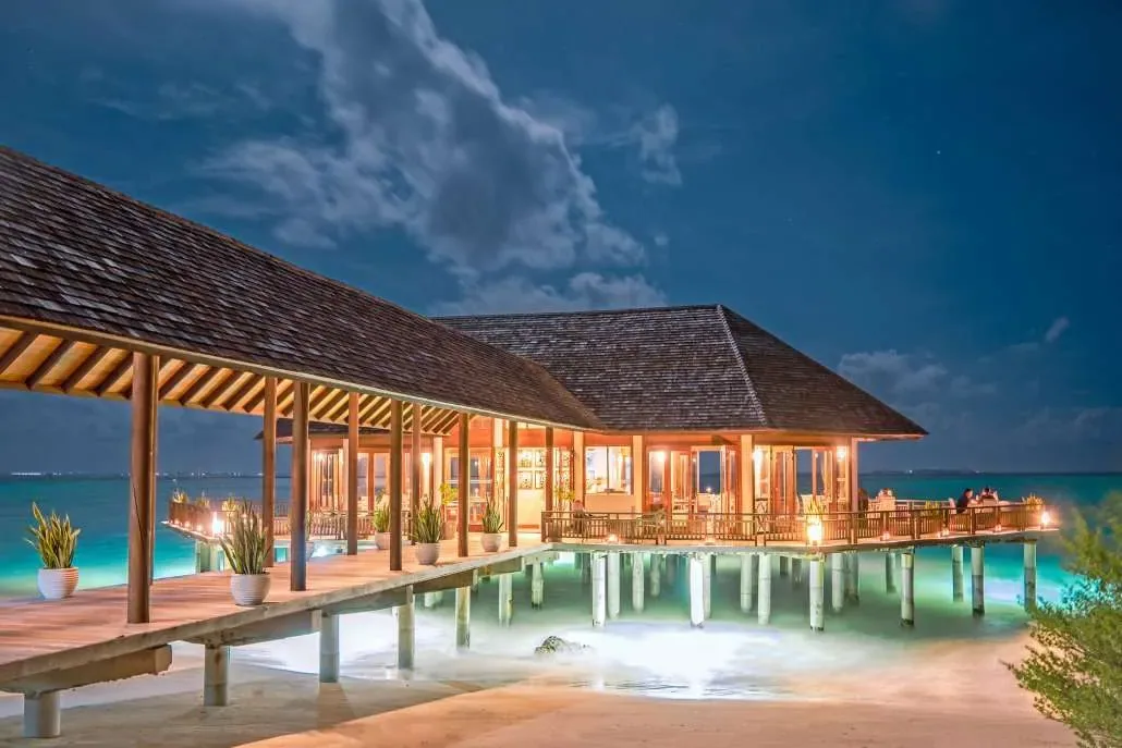 Hideaway Beach Resort & Spa, Samsara Asian-fusion overwater pavilion at dusk, Haa Alif Atoll, Maldives