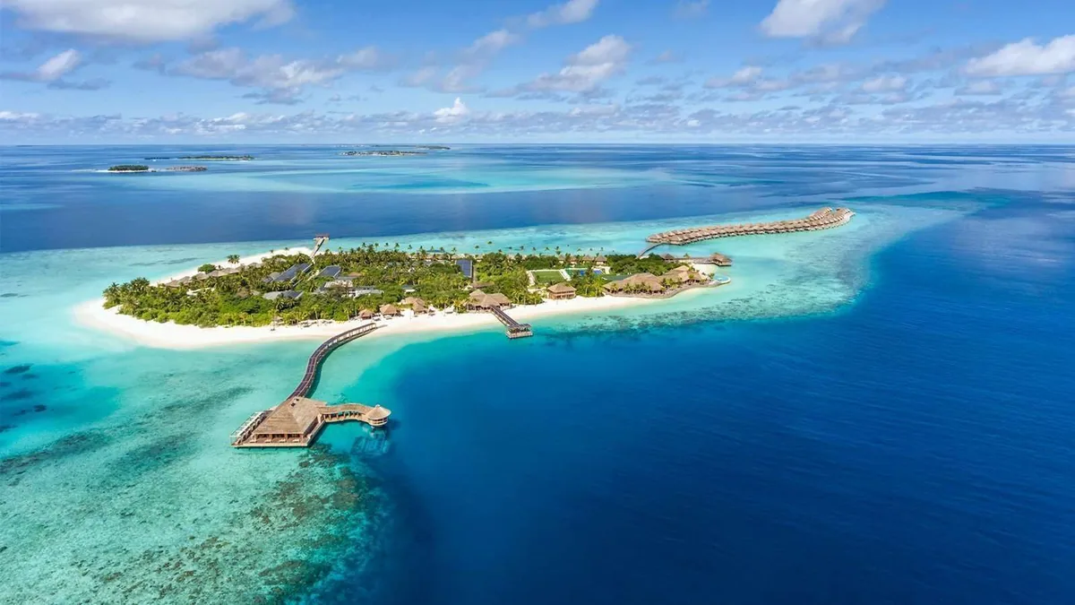 Hurawalhi Island Resort, aerial, Lhaviyani Atoll, Maldives, Hurawalhi Island Resort, the natural-island geometry in northern Lhaviyani Atoll with the over-water jetty cluster.