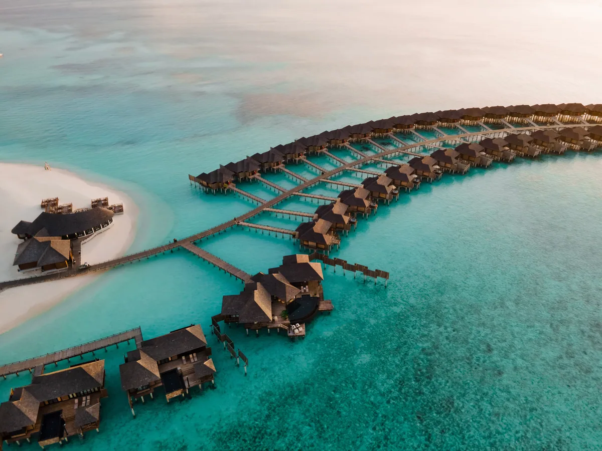 Sun Siyam Iru Veli, aerial, Dhaalu Atoll, Maldives, Sun Siyam Iru Veli, the Maaenboodhoo island geometry in southern Dhaalu Atoll with the over-water cluster on the lagoon side and the perimeter beach configuration.
