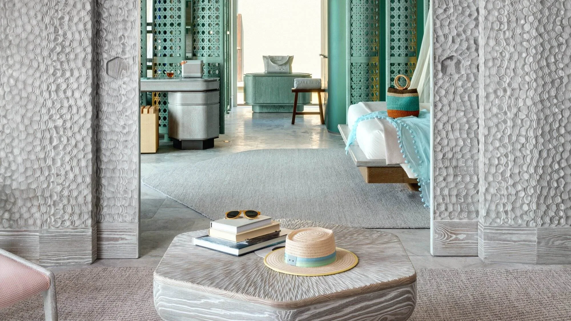 JOALI BEING, villa overwater, Raa Atoll, Maldives, Grand Ocean Pool Villa interior, textured pebble-finish wall panels framing the bedroom, soft green and neutral palette of the wellness-aligned material language.