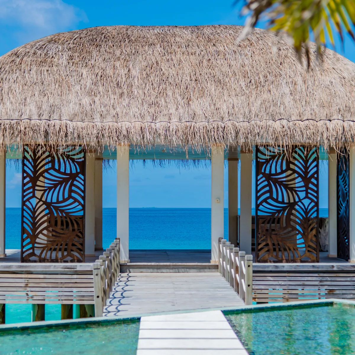JW Marriott Maldives Resort & Spa, SPA by JW yoga pavilion with palm-leaf-cut wood screens and overwater walkway, Shaviyani Atoll, Maldives