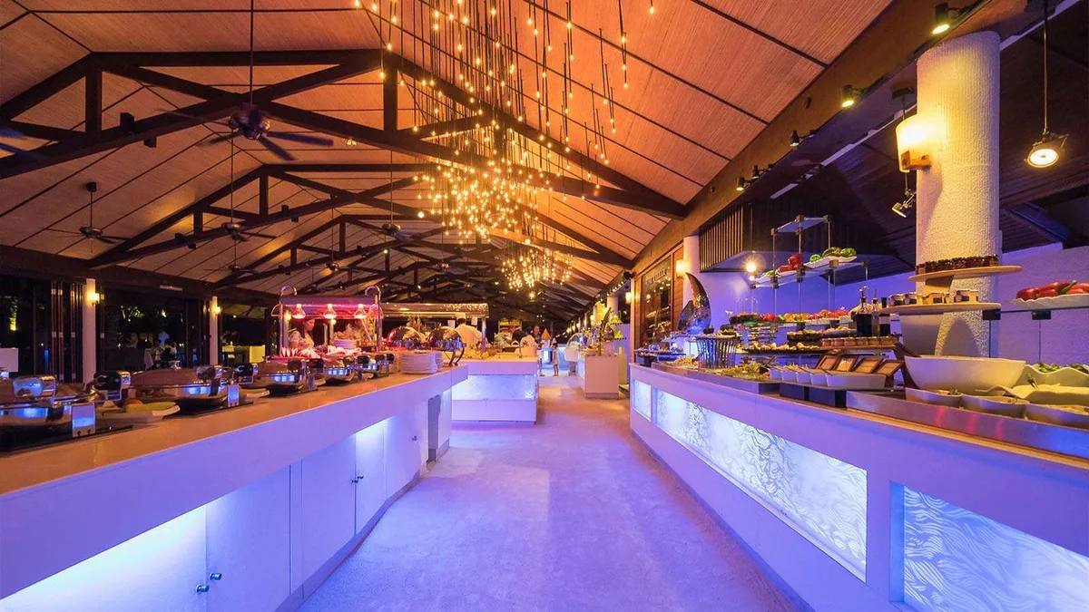Lily Beach Resort & Spa, dining, Alif Dhaal (South Ari) Atoll, Maldives, Lily Maa principal buffet under the exposed-truss pitched timber ceiling with the cascading fairy-light pendant and the blue-LED-uplit counter base.