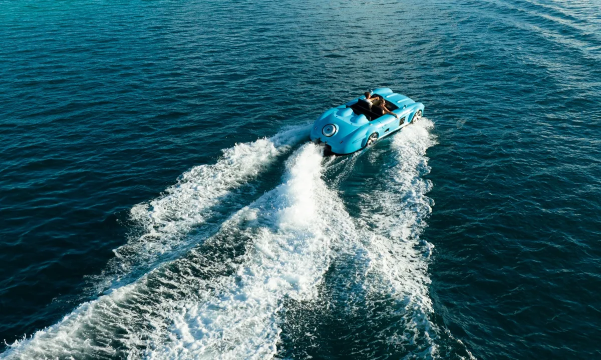 LUX* South Ari Atoll, activities, Alif Dhaal (South Ari) Atoll, Maldives, Powder-blue retro roadster-bodied jet car carving the lagoon at the SSOV (Sunset Sand Overwater Villa) activities amenity, the brand-portfolio signature toy.