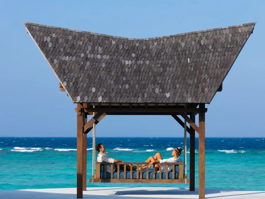 Mövenpick Resort Kuredhivaru, winged shingle-roof beachfront pavilion swing, Noonu Atoll, Maldives