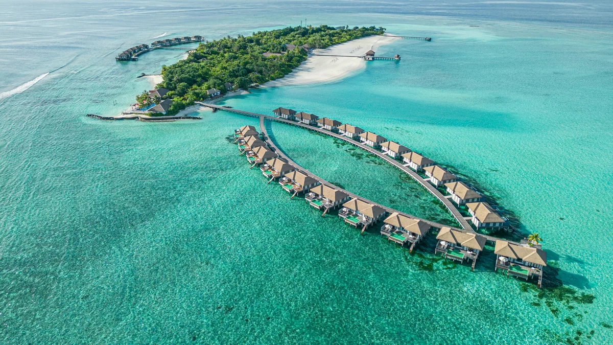 Noku Maldives, aerial of Kudafunafaru with V-shape overwater villa cluster, Noonu Atoll, Maldives