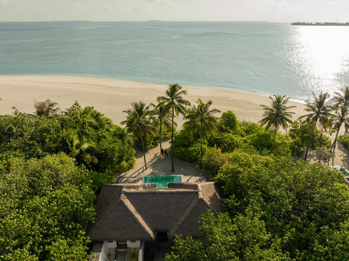 Noku Maldives, single Beach Pool Family Villa aerial with green-tile pool in palm canopy, Noonu Atoll, Maldives