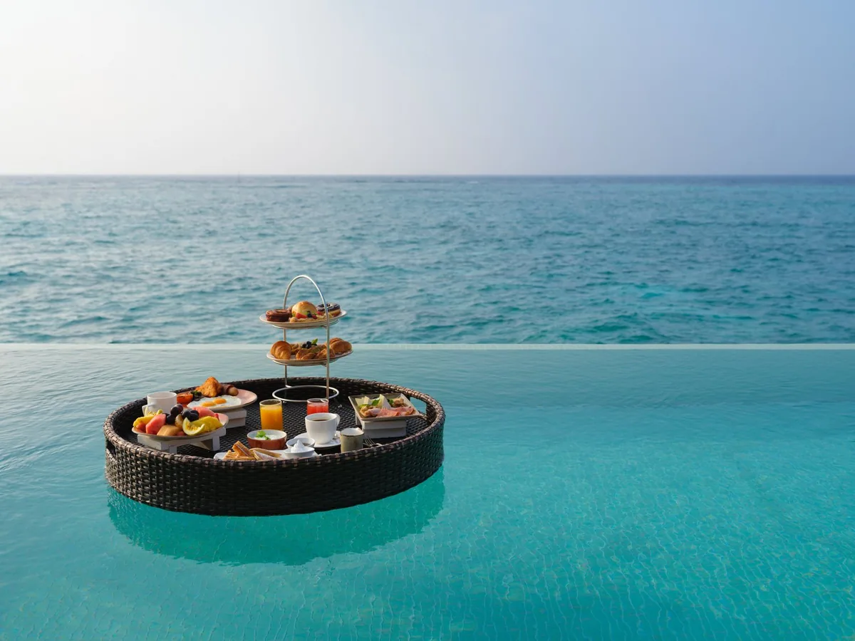 Noku Maldives, floating breakfast tray in villa infinity pool, Noonu Atoll, Maldives