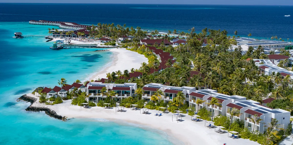OBLU XPERIENCE Ailafushi, aerial, North Malé Atoll, Maldives, OBLU XPERIENCE Ailafushi, the Ailafushi island geometry roughly 7 km east of Velana International with the substantial over-water jetty cluster and the beach perimeter configuration.