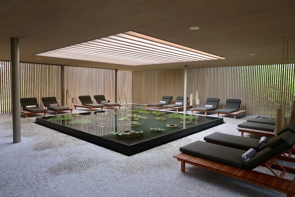 Patina Maldives, Fari Islands, spa, North Malé Atoll, Maldives, FLOW plunge-pool circuit, hot and cold pools framed by the MK27 reeded-wood walls and timber decking, the active-recovery zone that bridges the treatment suites and the wellness arc programme.