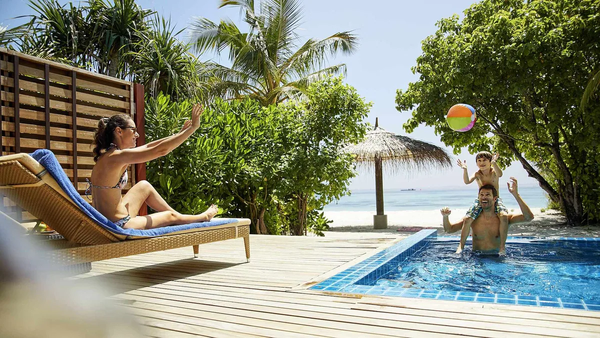 Robinson Club Noonu, Pool Beach Villa with family in private plunge pool, thatched parasol over wooden deck and beach access to turquoise lagoon, Noonu Atoll, Maldives