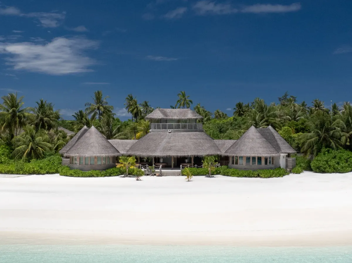 Six Senses Laamu aerial showing the over-water villa village along the reef on Olhuveli island, Laamu Atoll.
