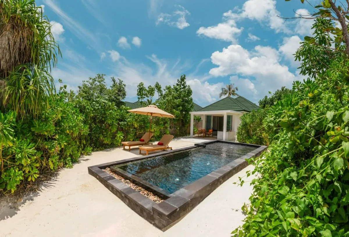 Siyam World Maldives, Beach Villa with Pool exterior with private plunge pool, terracotta sun loungers under beige parasol and tropical jungle, Noonu Atoll, Maldives