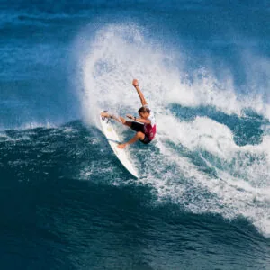 Surfer being coached at a Baa Atoll break off Soneva Fushi.