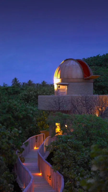 Observatory dome and telescope at twilight on Kunfunadhoo island at Soneva Fushi.