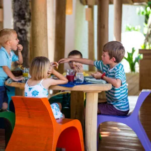 Children playing inside The Den open-pavilion playroom at Soneva Fushi.