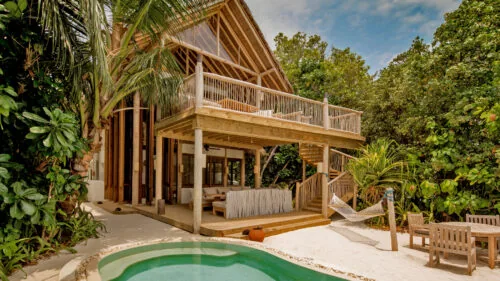 Two-bedroom Crusoe Suite with private pool at Soneva Fushi, mid-tier beach residence.