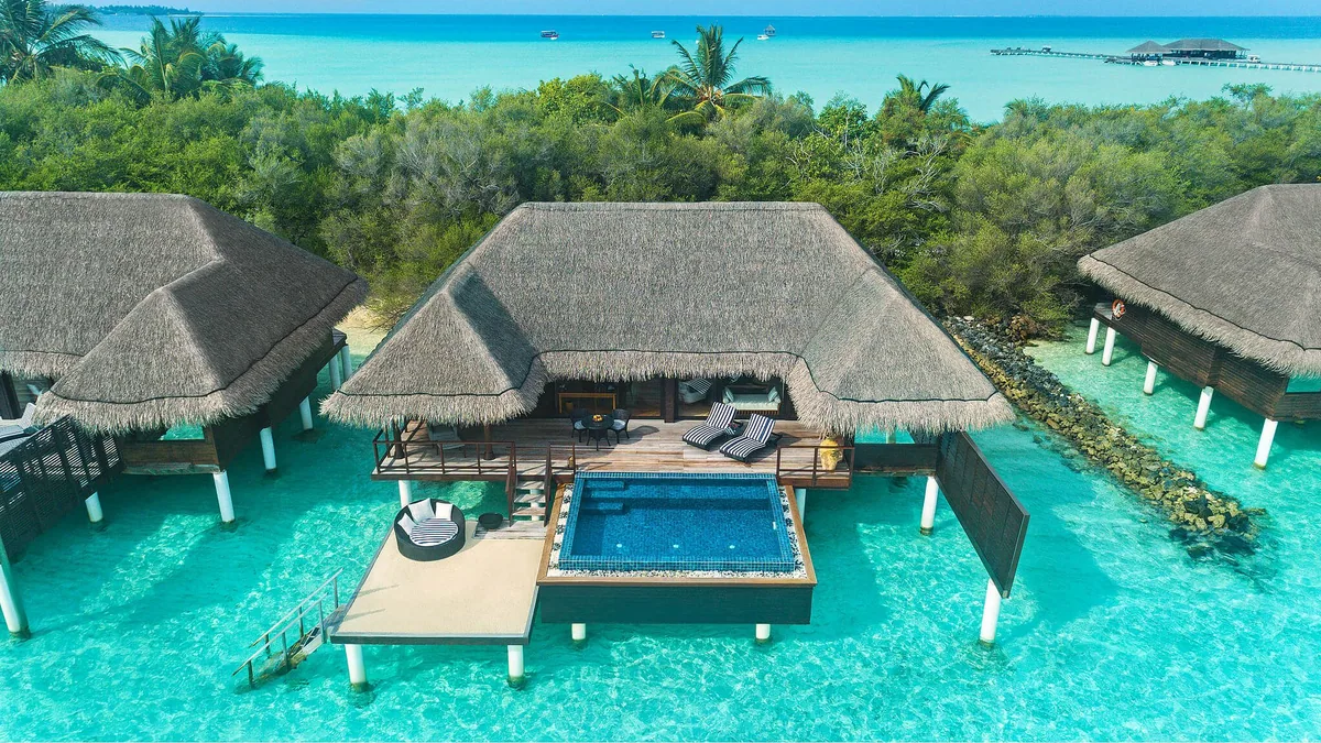 Taj Exotica Resort & Spa, Maldives, villa overwater, South Malé Atoll, Maldives, One Bedroom Ocean Suite with Pool exterior, a thatched-roof overwater pavilion with private deck, plunge pool flush with the lagoon, and ladder-access to clear water below.