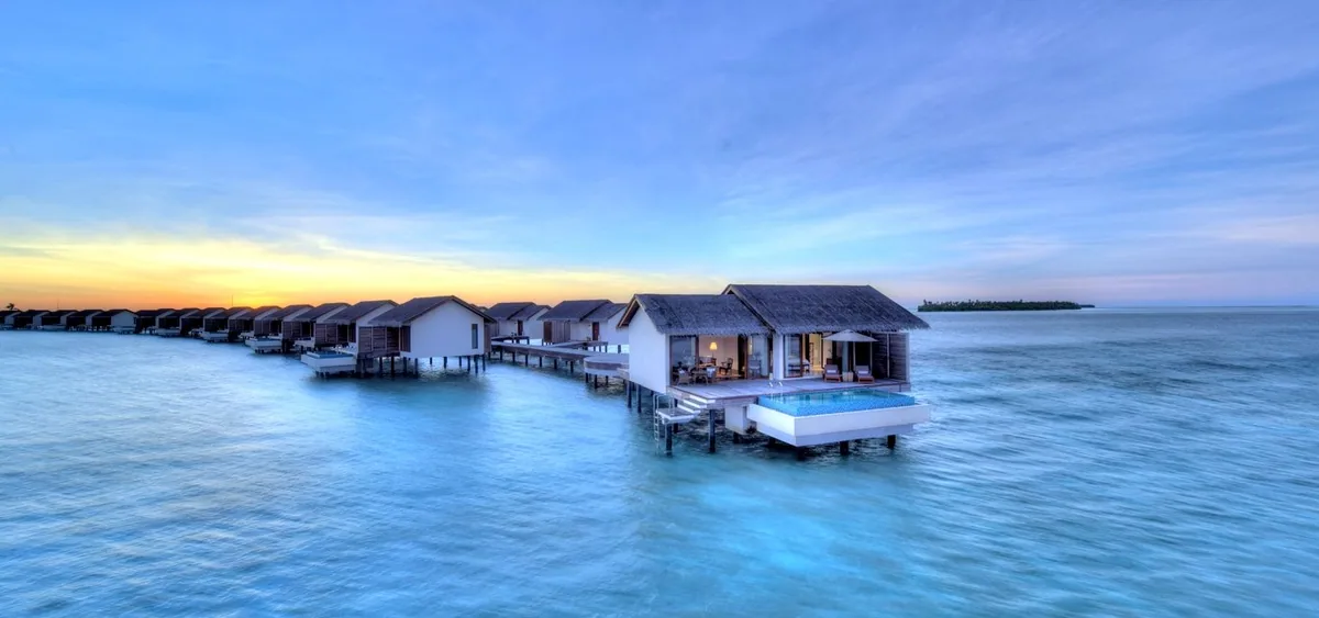 The Residence Maldives at Falhumaafushi, aerial, Gaafu Alifu Atoll, Maldives, The Residence Maldives at Falhumaafushi, the Falhumaafushi island geometry in Gaafu Alifu Atoll with 94-villa adult-leaning configuration plus 6-kilometre over-water bridge link to sister property Dhigurah (among the country's longest over-water bridges).