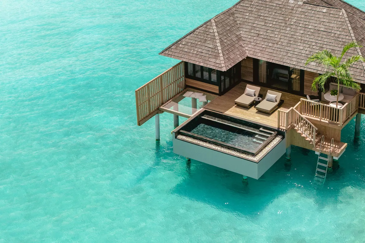 Sun Siyam Iru Fushi, Sunset Horizon Water Villa with Pool pyramid-roof villa with glass-edge plunge pool over lagoon, sun loungers and lagoon ladder, Noonu Atoll, Maldives