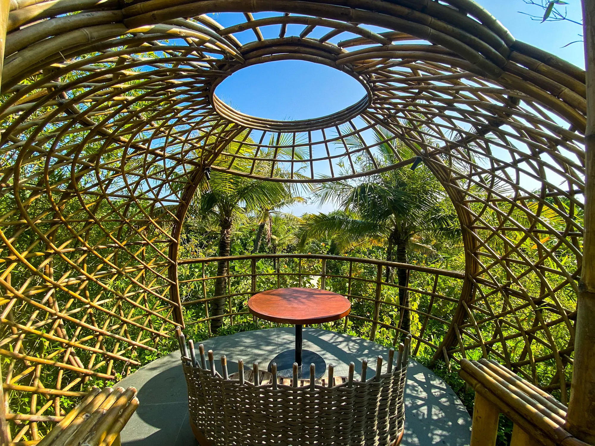 Waldorf Astoria Maldives Ithaafushi, dining, South Malé Atoll, Maldives, Terra dining pod interior, hand-crafted bamboo lattice sphere with open oculus, single round table cocooned in the tree canopy for the seven-course seasonal menu.